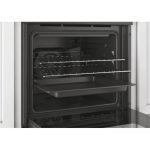Forno Candy Classic FCC604GH/E 65L incassato con sportello aperto, vista interna cavità con griglie e leccarda