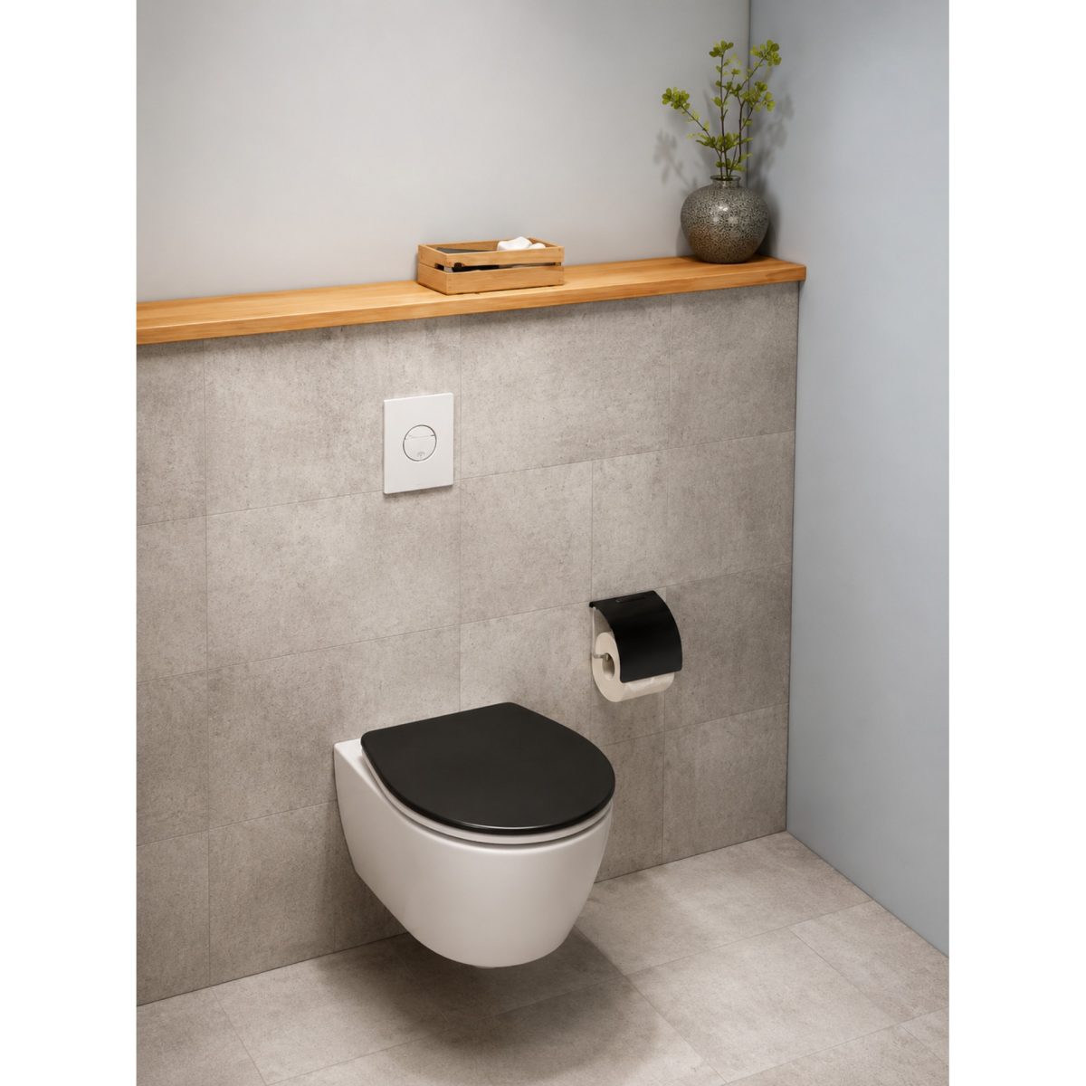 Copriwater Wenko nero installato su WC sospeso bianco, ambientazione bagno moderno