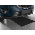 Tappetino Officina e Garage Ultimate Speed nero posizionato sotto il paraurti anteriore di un'auto in un box